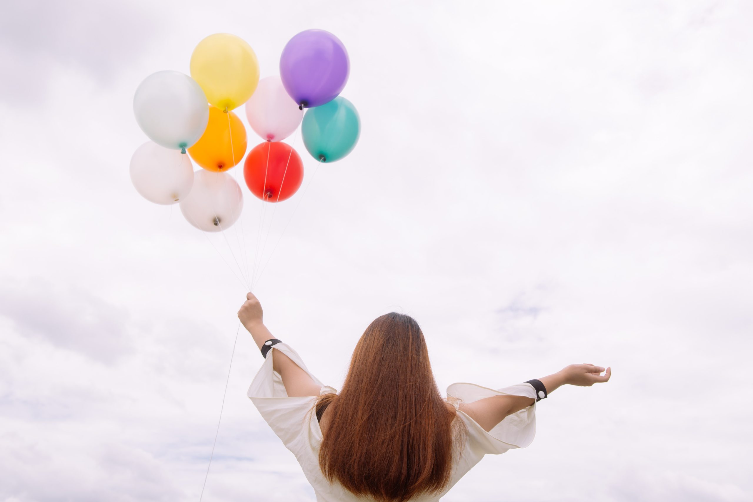 worm-s-eye-view-of-woman-holding-balloons-887824